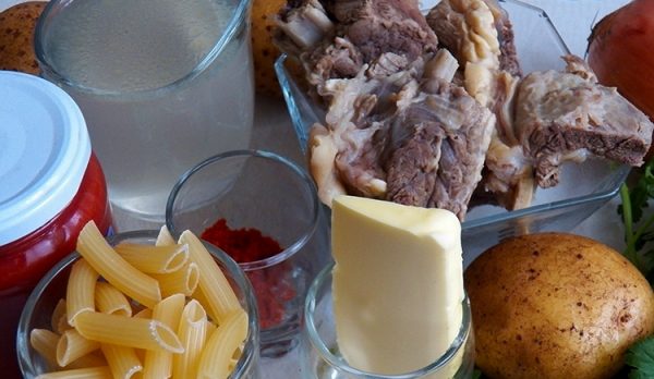 Продукты для приготовления говяжьего супа с макаронами и картофелем на столе