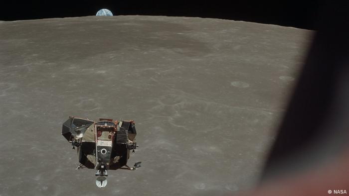 The Apollo 11 Lunar Module with moon and earth in the background.