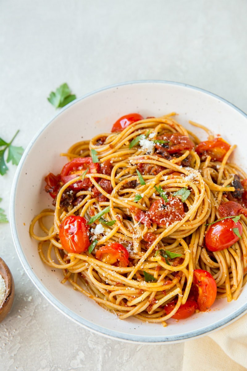 spaghetti with three tomato sauce in a white bowl